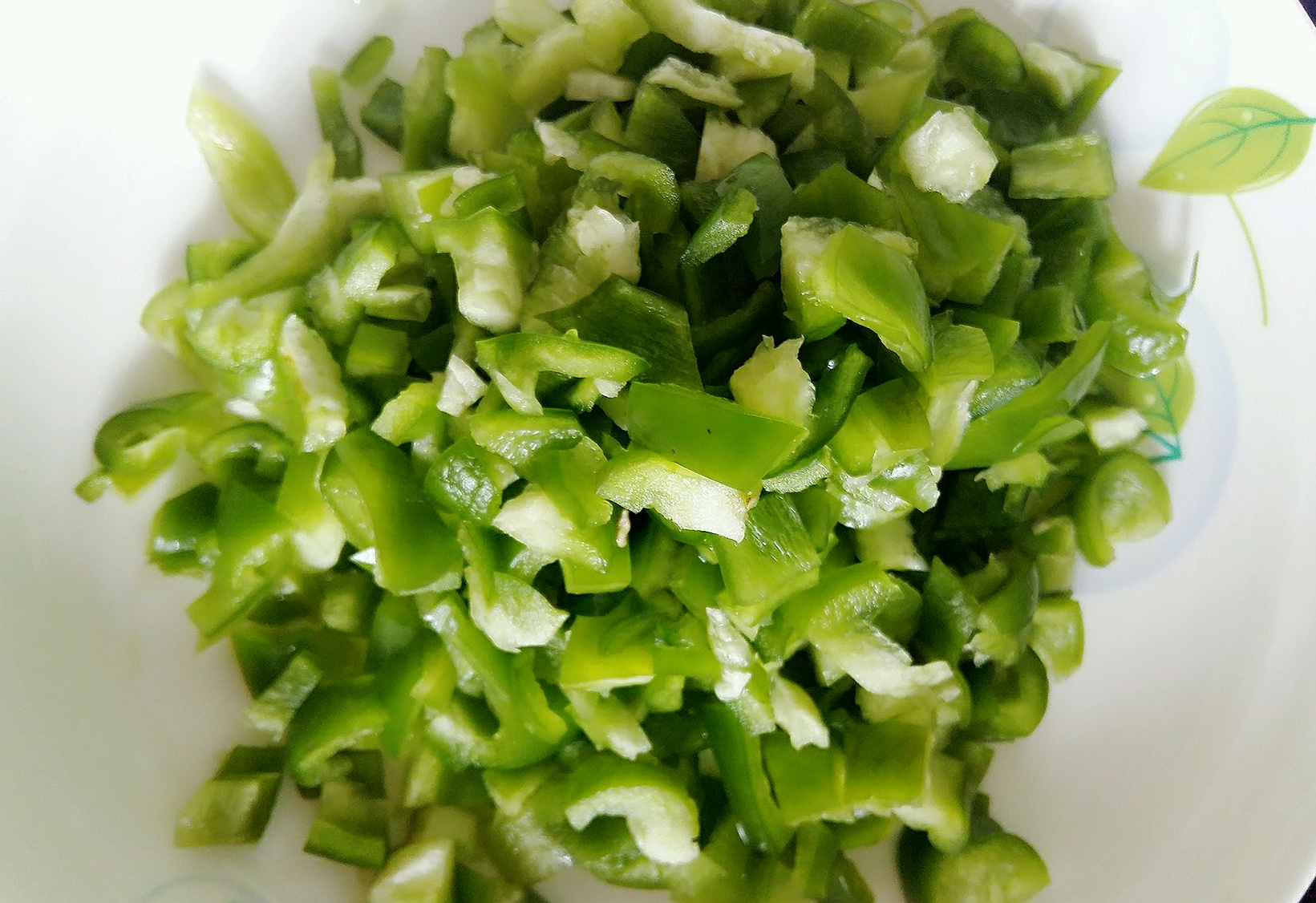 Prepare 150g green bell peppers by rinsing and chopping them.