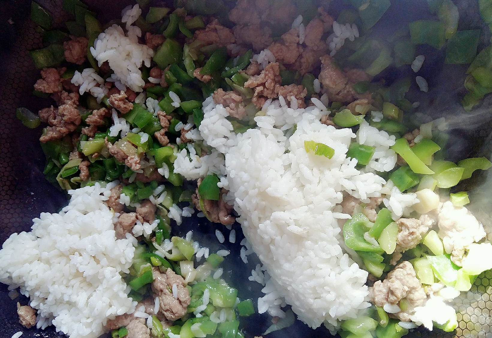 Stir-fry pork, bell peppers, and leftover rice together.