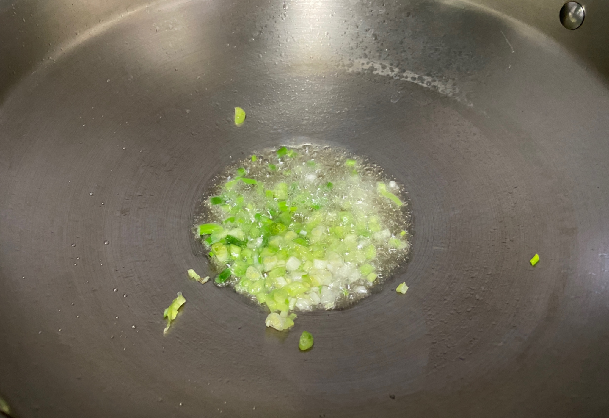 Sauté scallions in oil for fragrance.