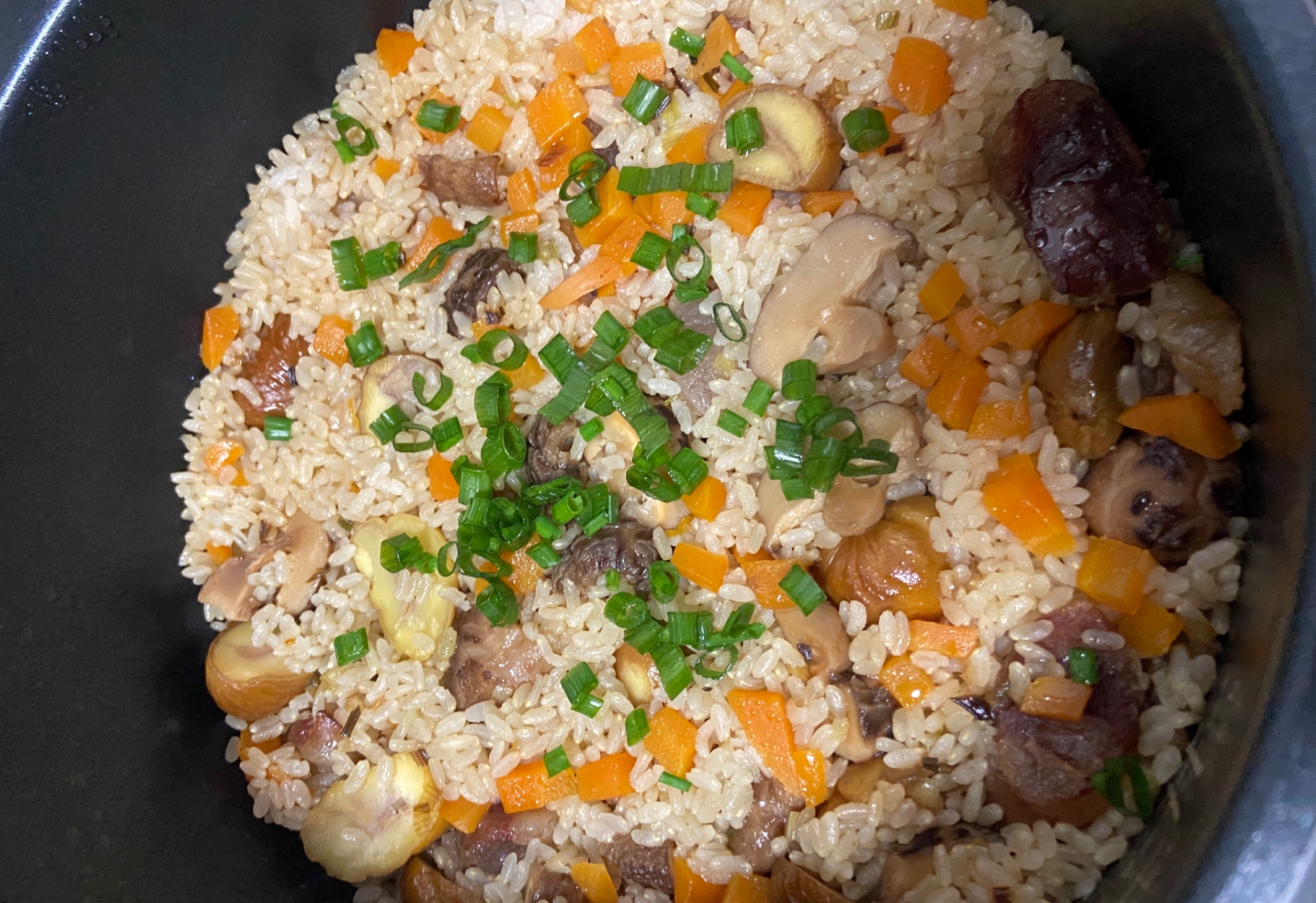 Garnish with scallions for a tasty sausage rice dish.