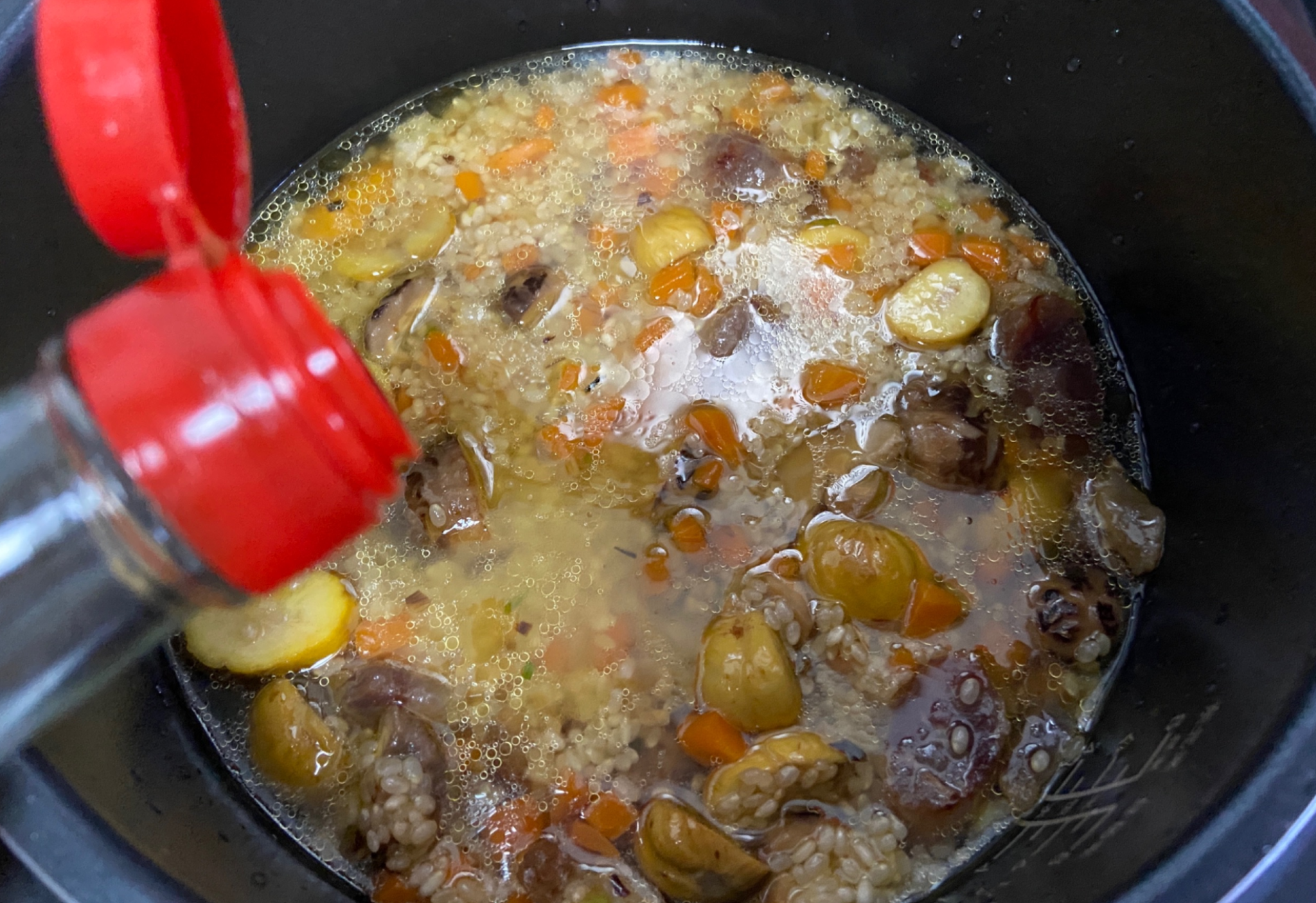 Add water to cover rice, drizzle sesame oil for flavor.