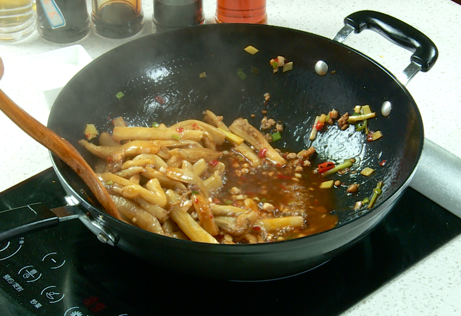 Add fried eggplant strips and stir to coat with sauce.