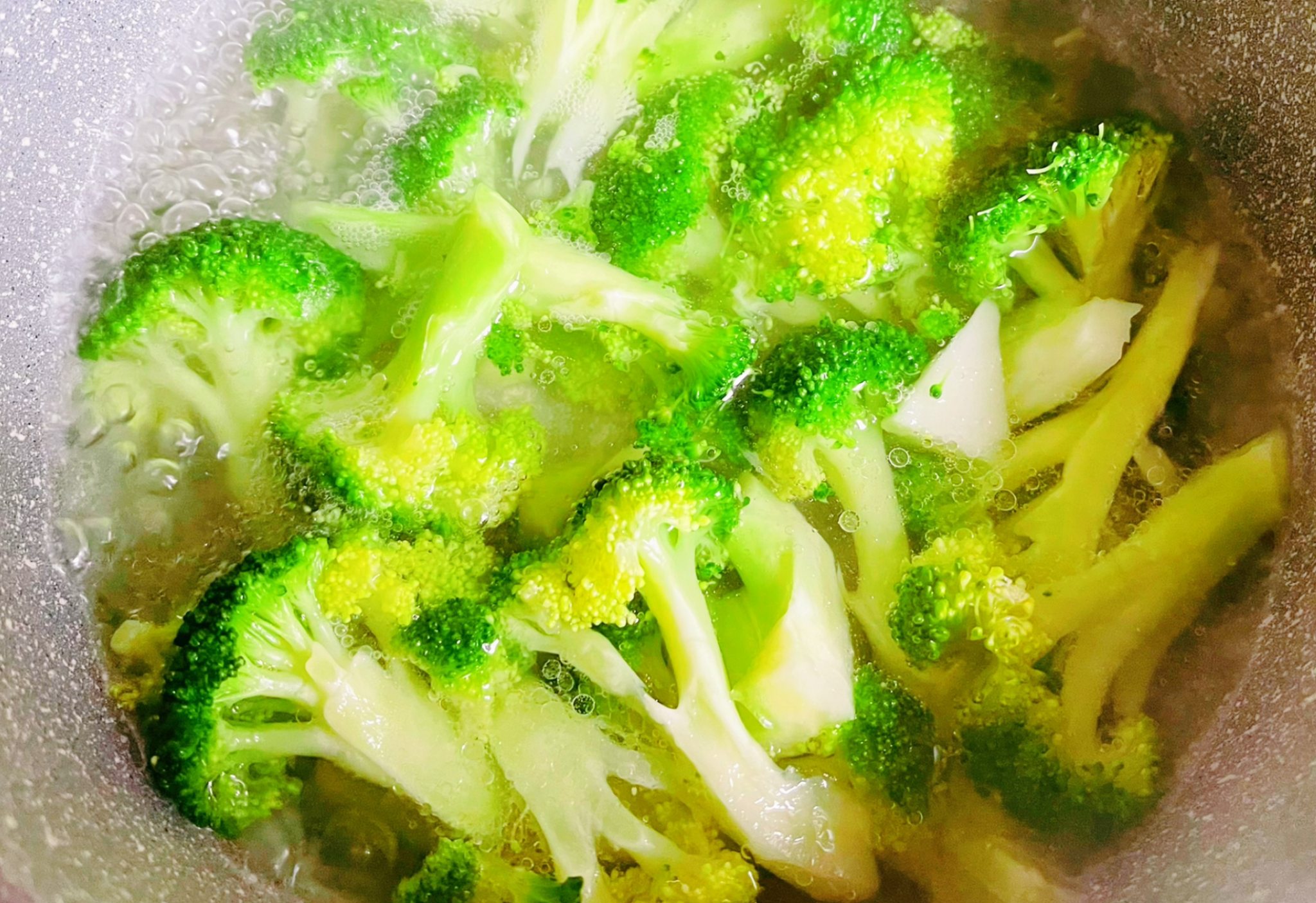 Blanch broccoli in boiling water with salt and oil for a brief period. Prevent overcooking to avoid mushiness.