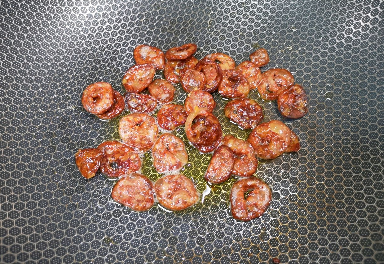 Pan-fry sausage slices until cooked, then set aside.