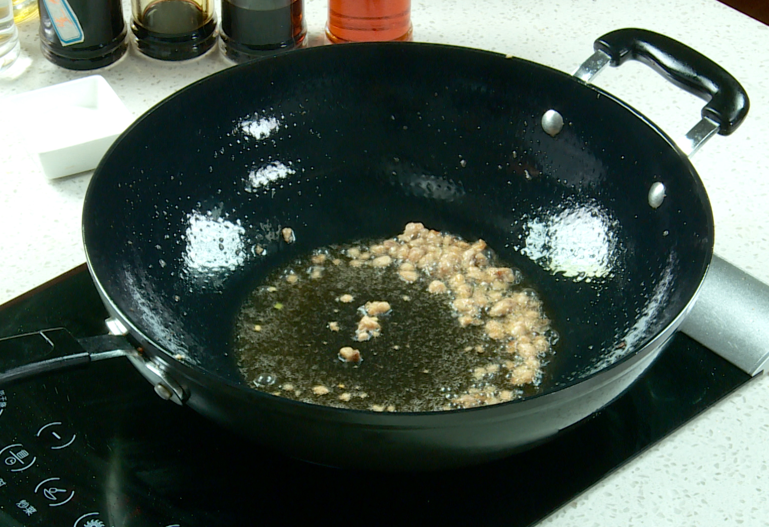 Cook salted fish by stir-frying in oil until slightly yellow.