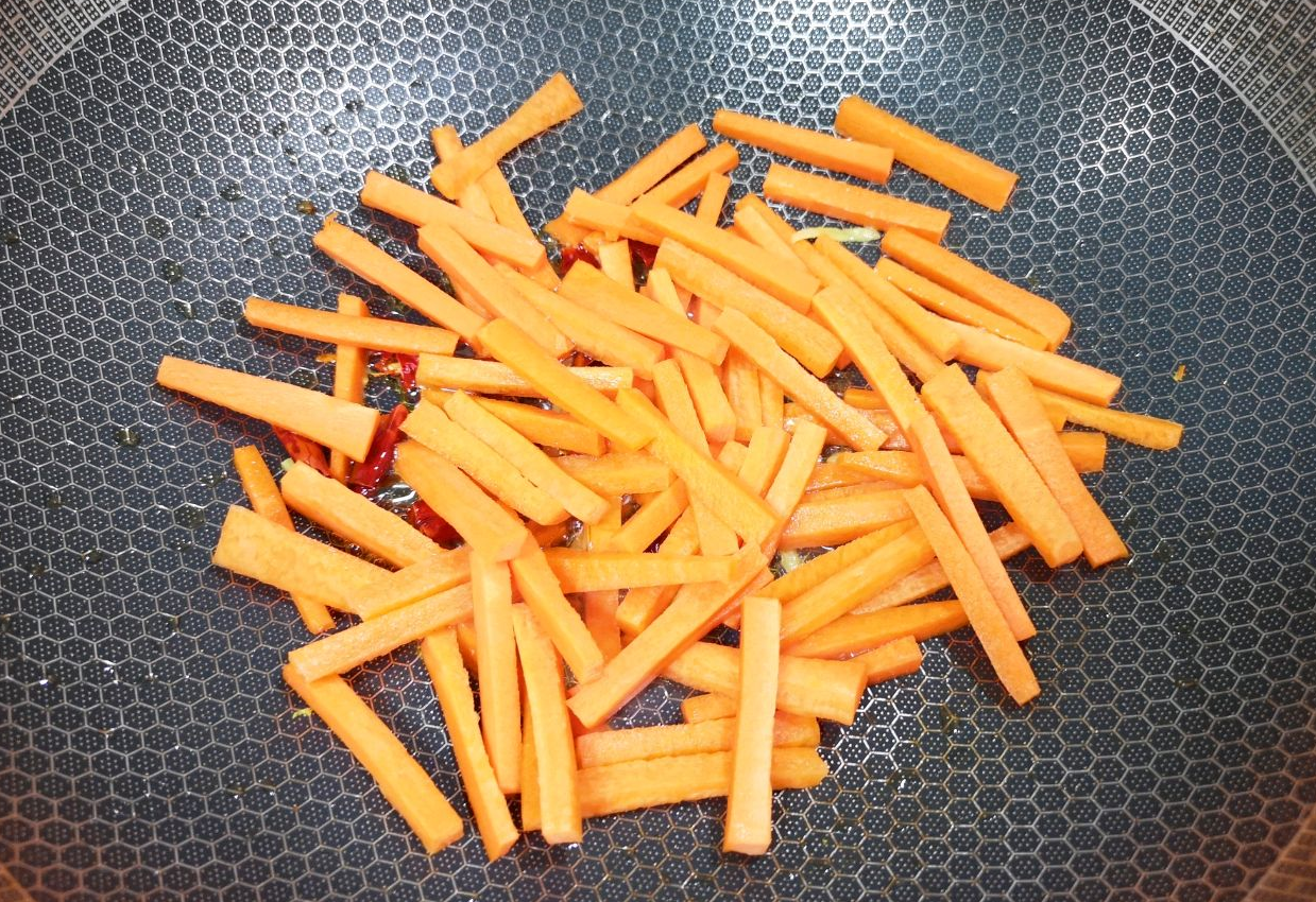 Add carrot strips to stir-fry evenly.