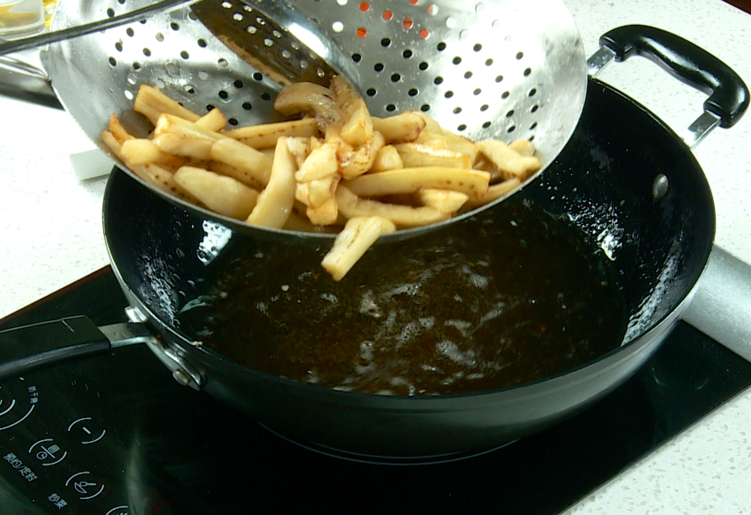 Fry eggplant in hot oil until golden brown, then drain.