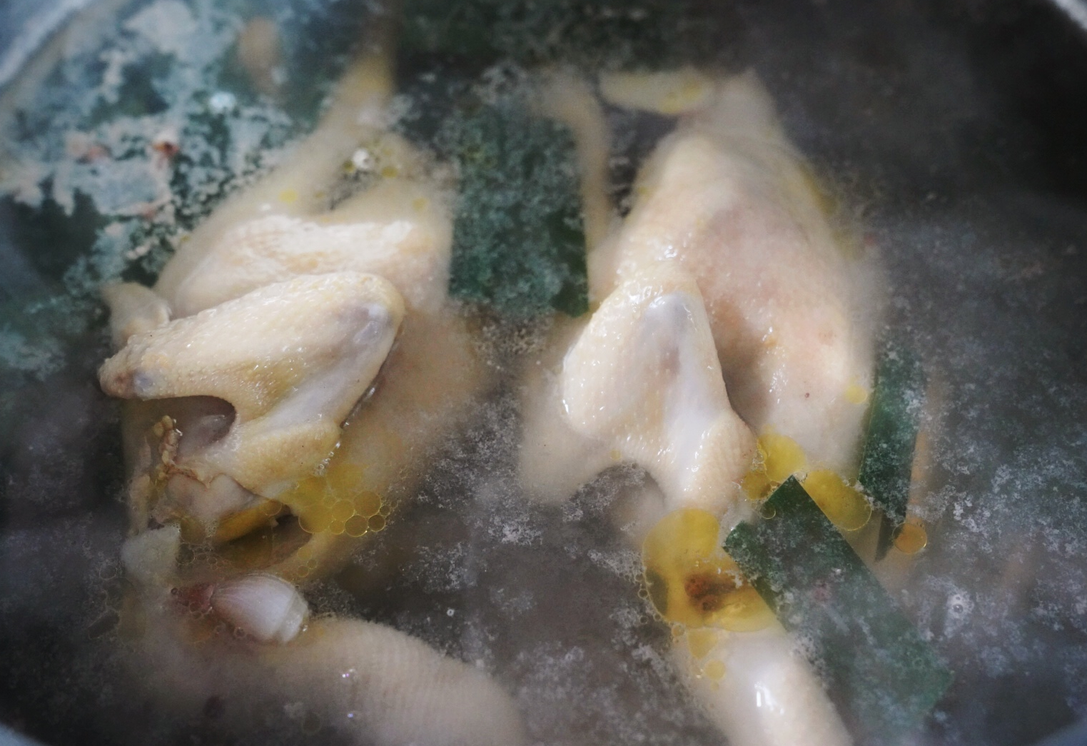 Submerge whole chicken in boiling water, let soak for 30 minutes.