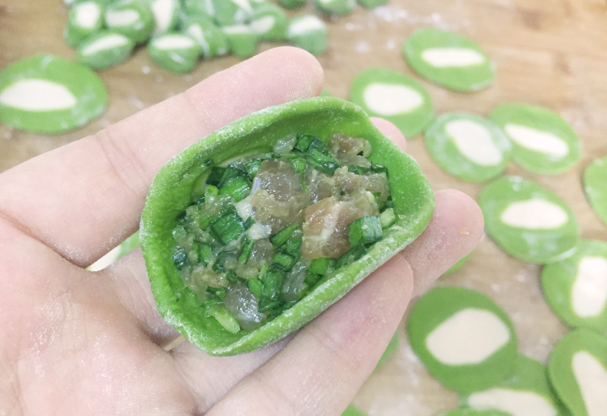 Form a dumpling wrapper into a bowl shape, then add filling.