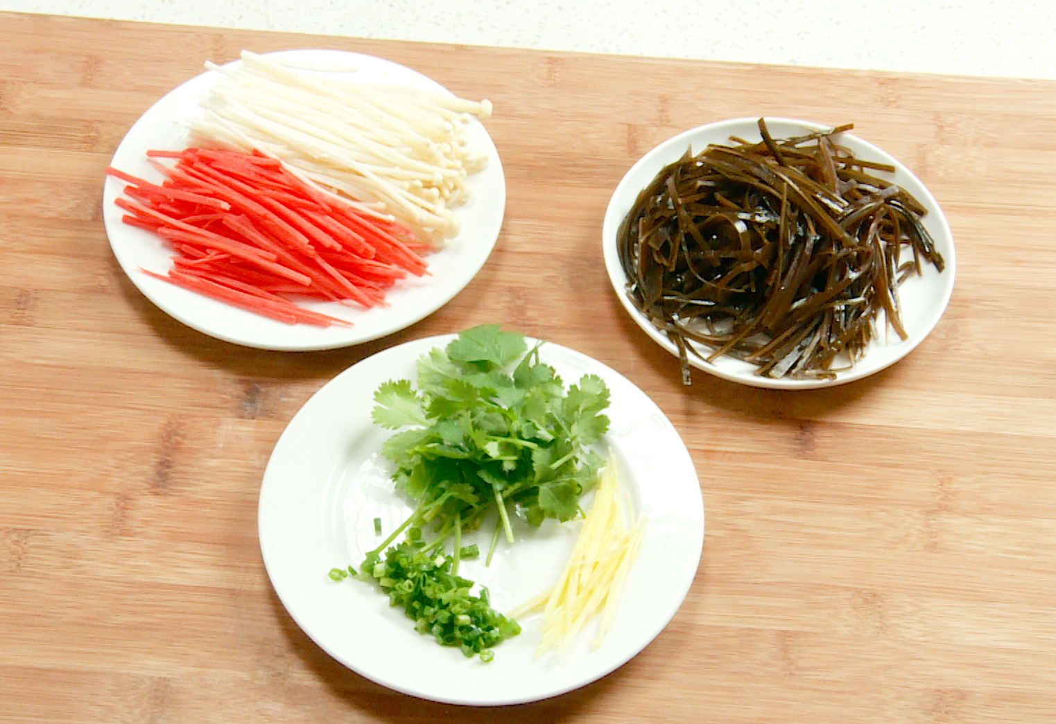 Prepare ingredients: cut kelp, enoki mushrooms, carrot, ginger, cilantro, and green onion.