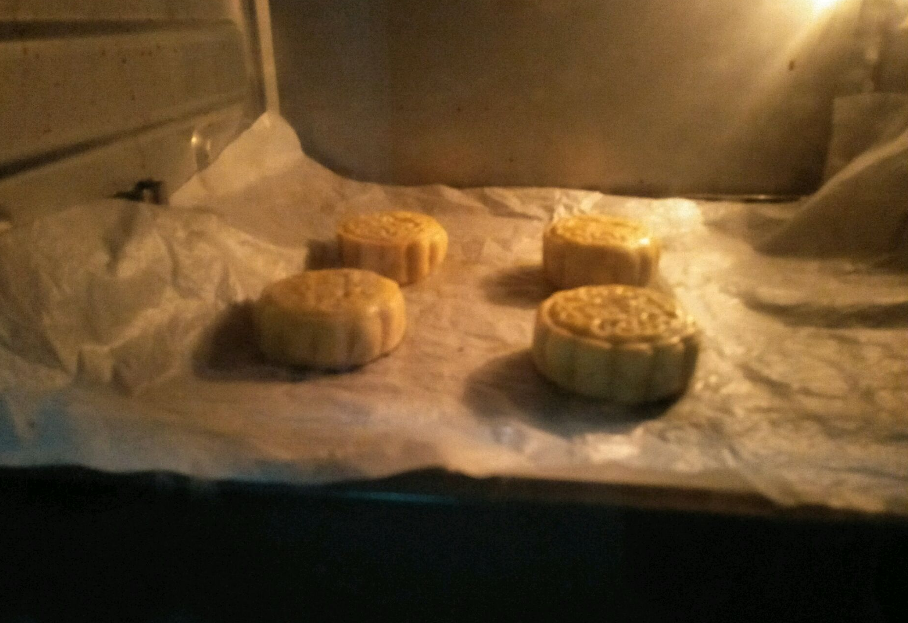 Bake mooncakes at 150°C for 30 mins, wrap in plastic wrap, rest overnight for better flavor. Let them sit before eating.