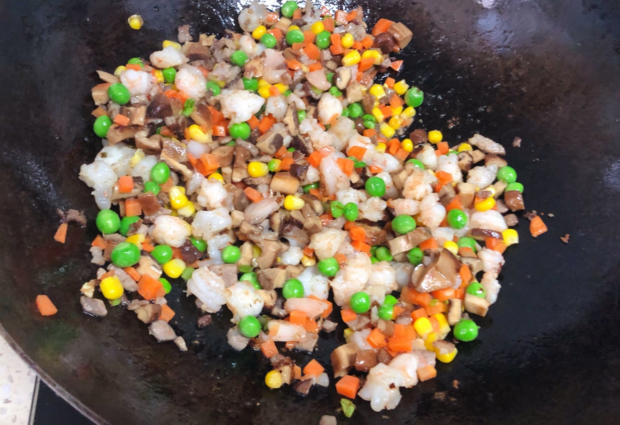 Sauté scallions, add pork, oyster sauce, veggies, shrimp, corn, and rice to make a delicious stir fry.