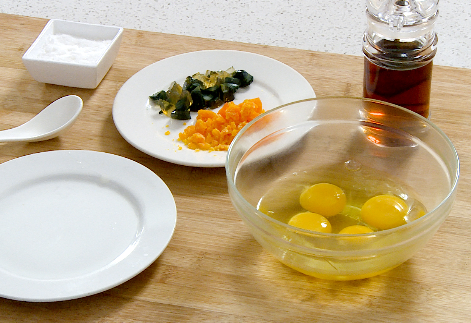 Instructions on preparing century egg, salted egg yolks, and regular eggs for cooking.