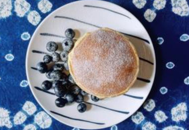 Serve pancakes with blueberries & powdered sugar.