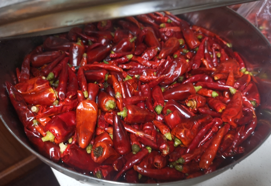 Soak chili peppers in hot water for at least four hours, changing water if needed.