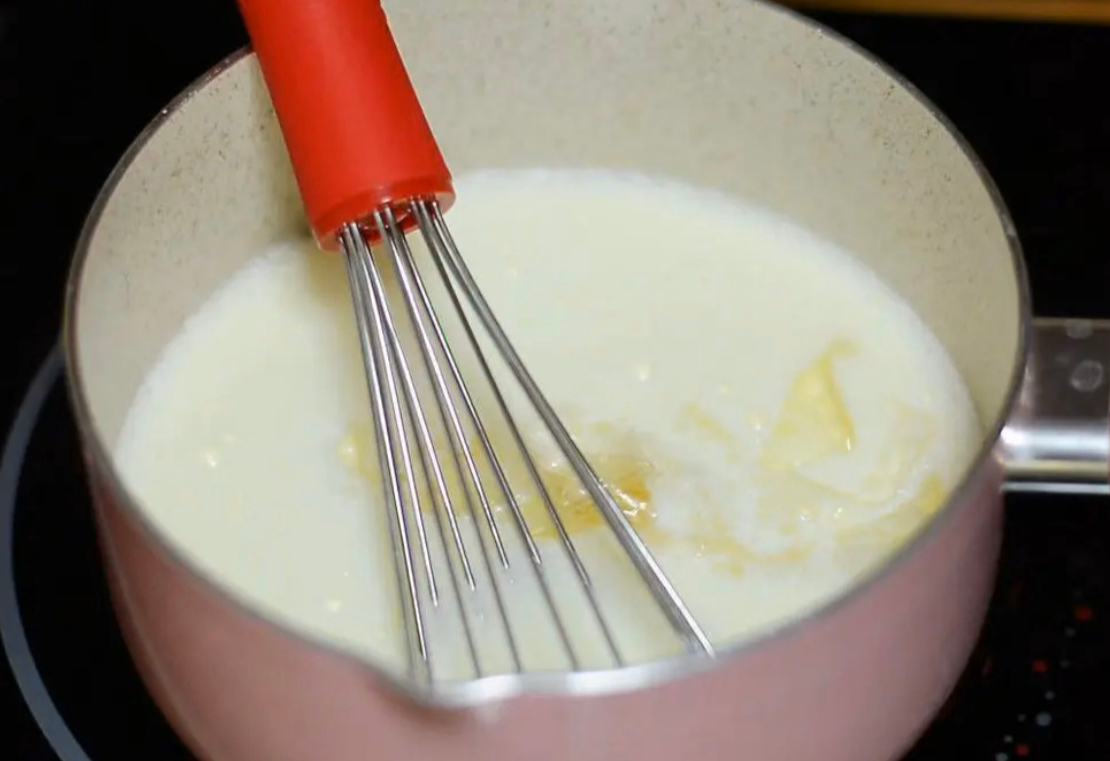 Add softened and drained gelatin sheets to the mixture, stirring until dissolved.