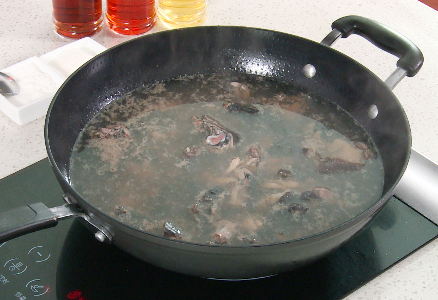 Blanch chicken by boiling in water until cooked through, then rinse in cold water.