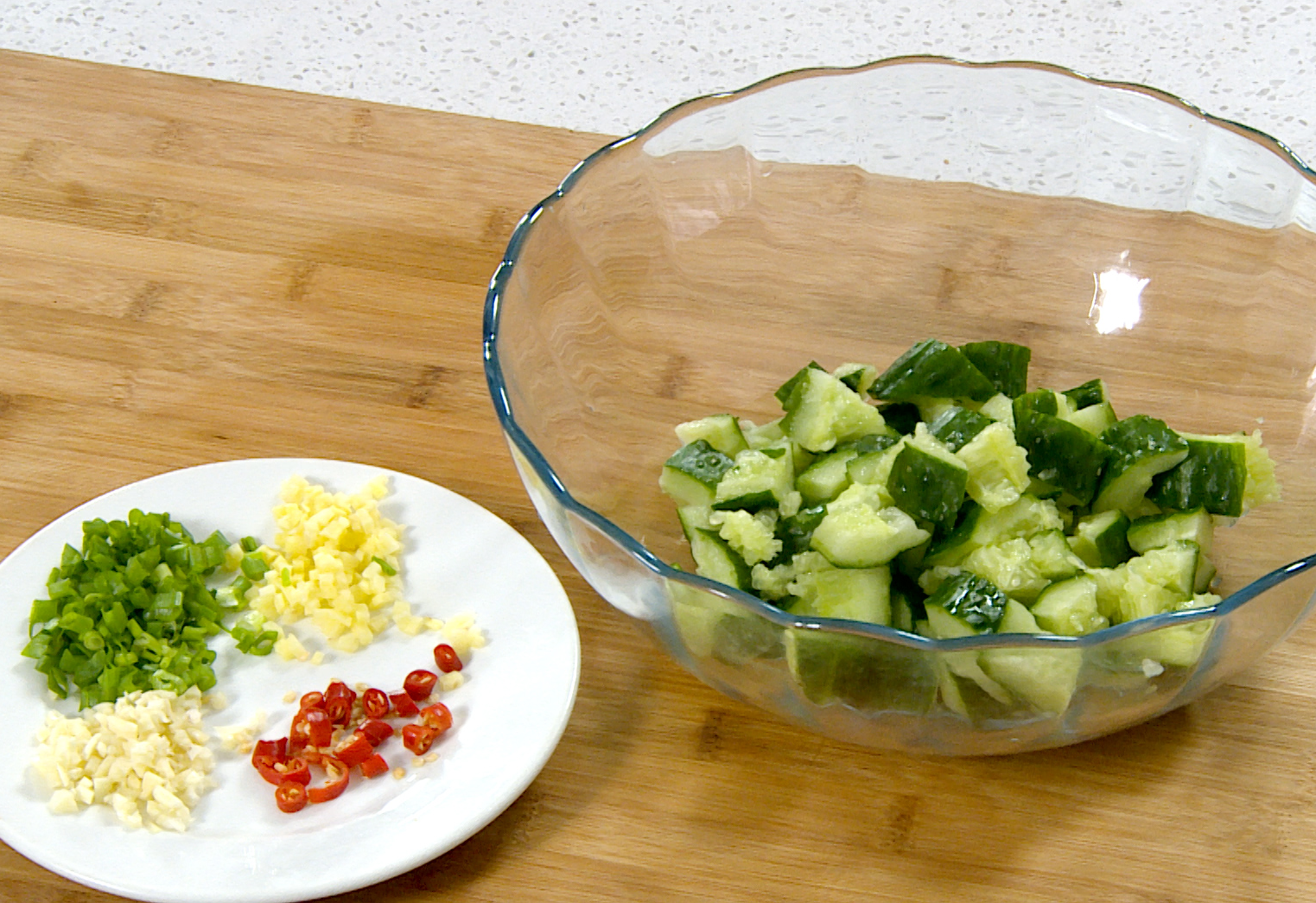 Prepare aromatics for cooking: slice chili (optional), mince ginger, and chop garlic and green onion.