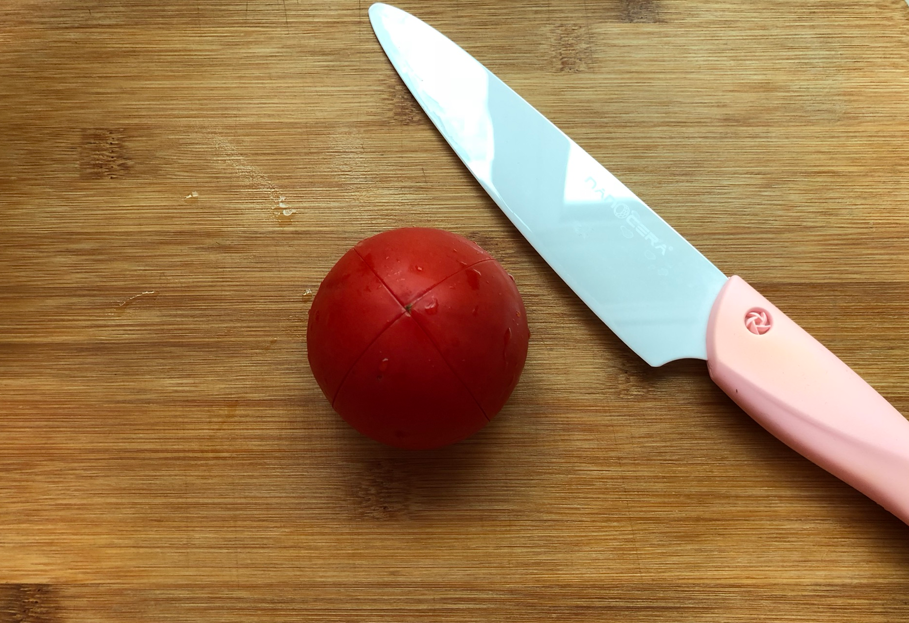 Gather ingredients and cross-cut tomatoes for preparation.