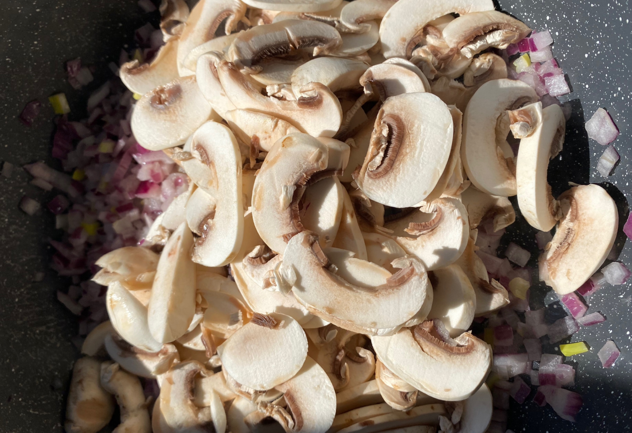 Add sliced mushrooms and stir into mixture.