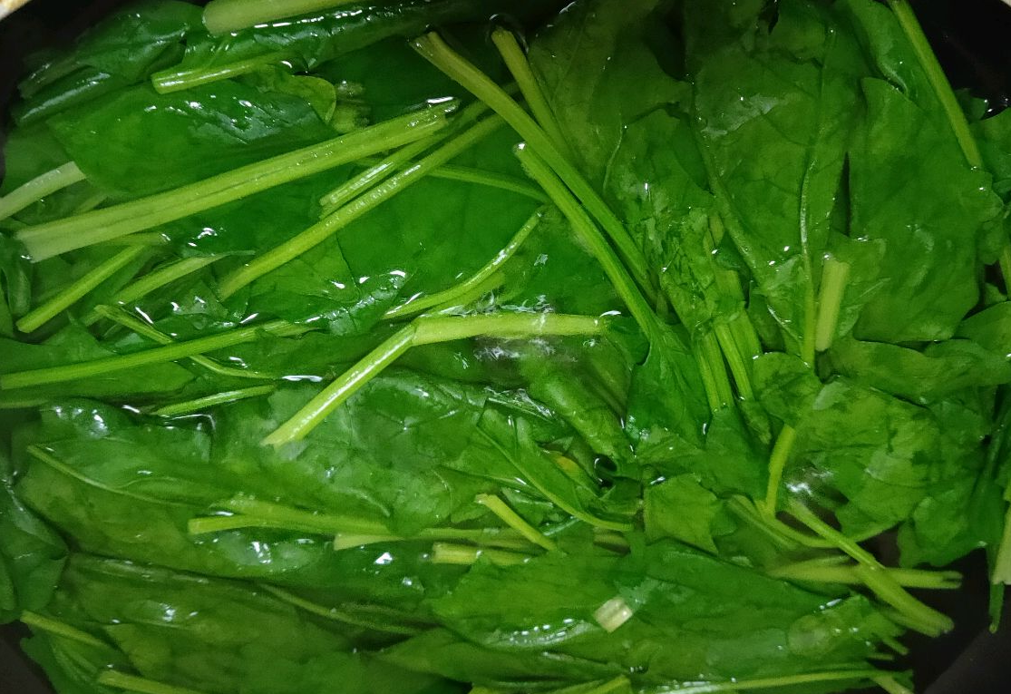 Blanch spinach briefly to cook it and remove any unpleasant taste.