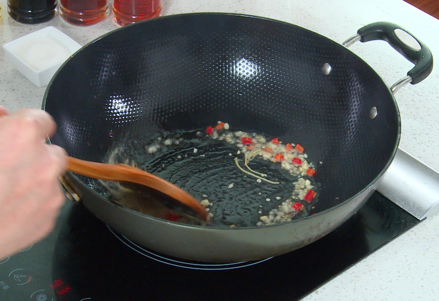 Sauté ginger, garlic, and chili in a pan for 1-2 minutes until golden.