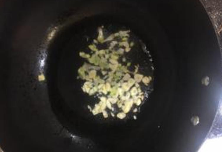 Sauté minced garlic in hot oil until fragrant.