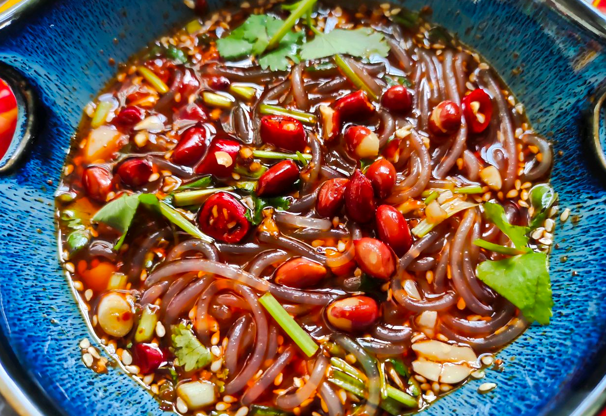 Add fried peanuts to finish tangy, spicy noodle dish.