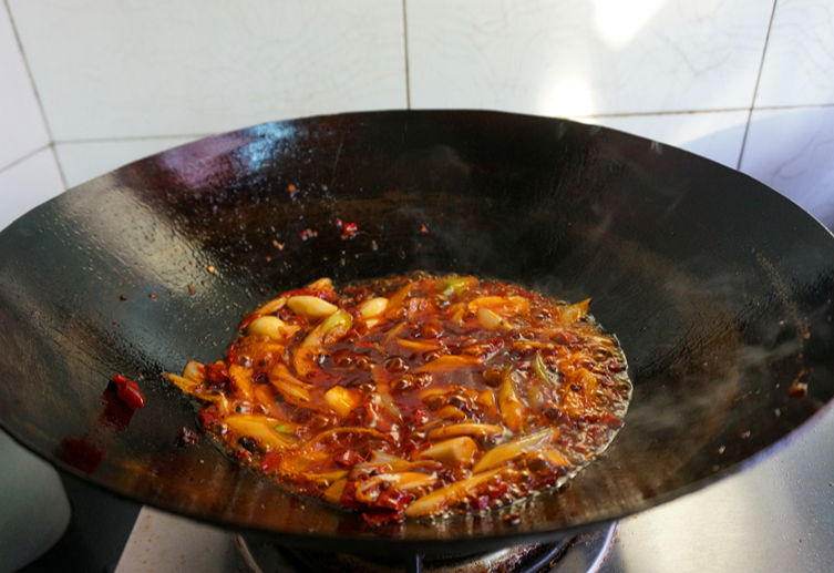 Cook stir-fry until oil is red and aromatic.