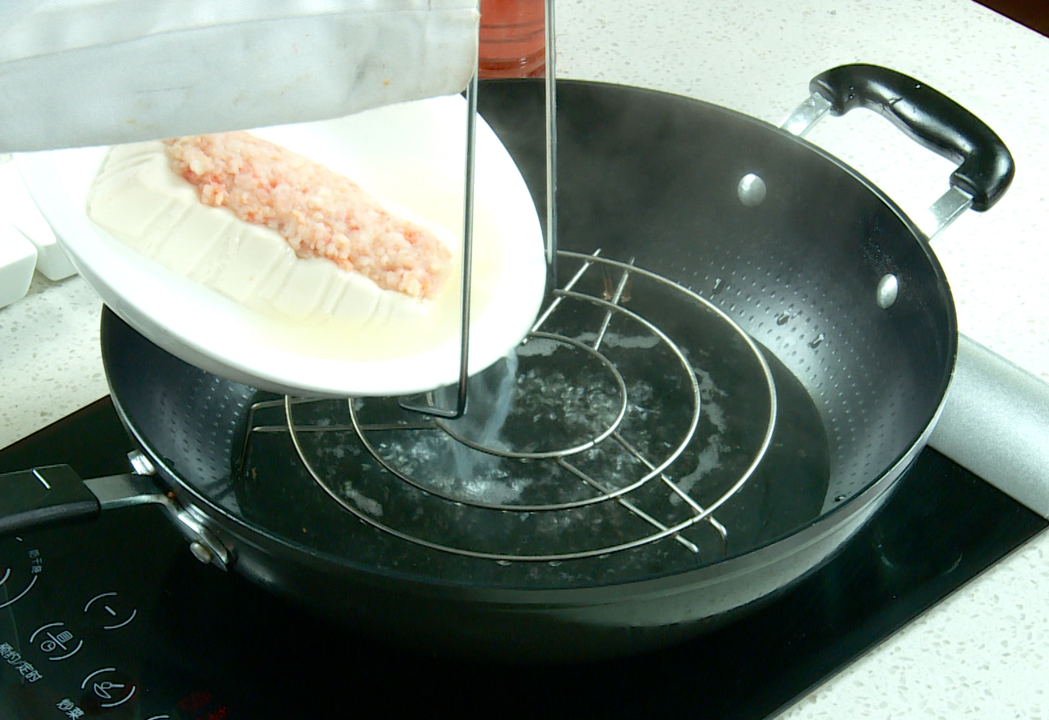 Steam tofu in a pot for 15 minutes, drain excess water after steaming.