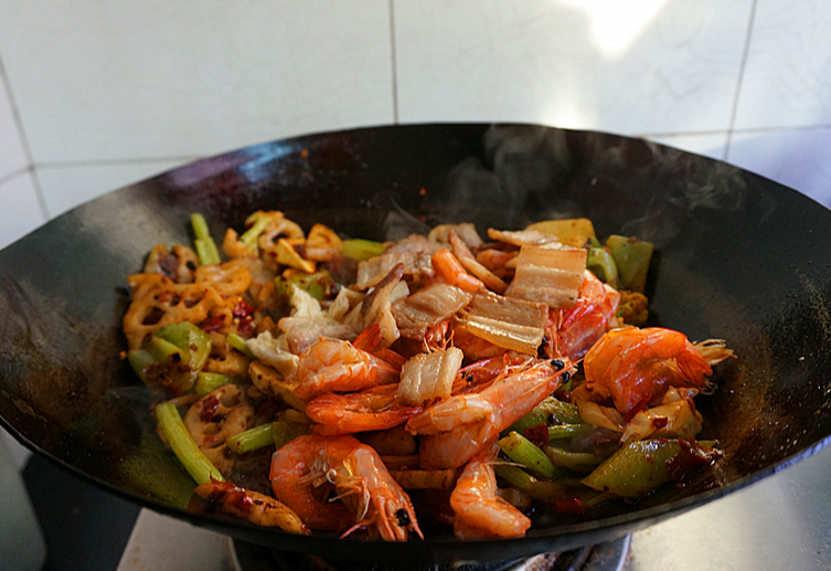 Cook pork belly and shrimp with salt, bouillon, and sugar until well mixed.