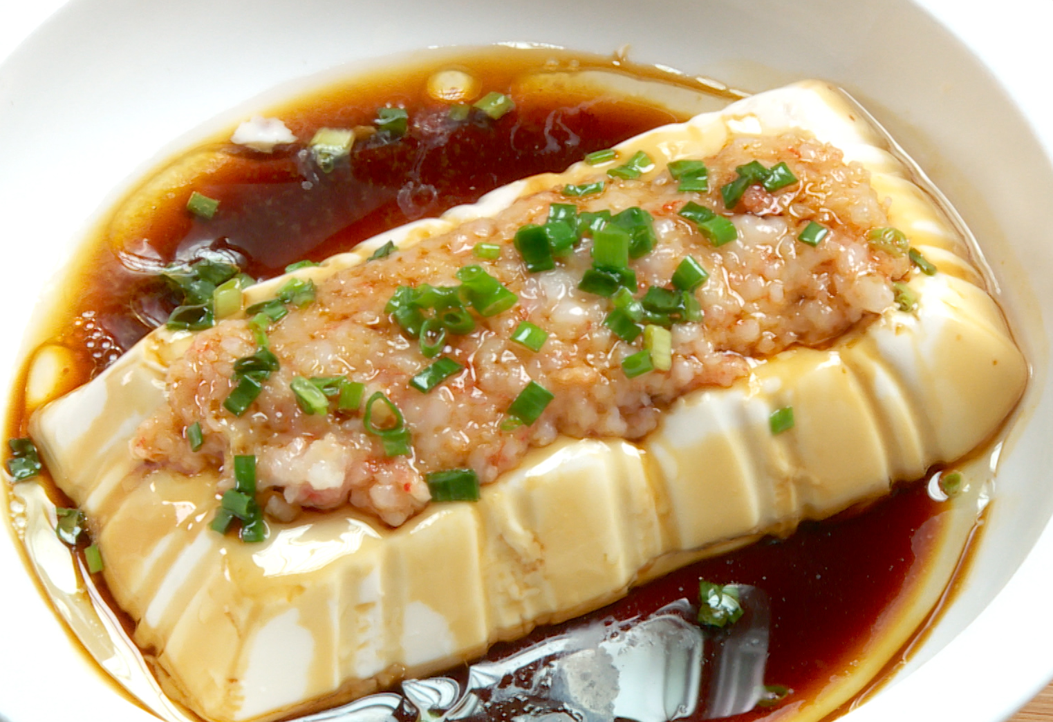 Serve immediately to enjoy tender tofu and flavorful shrimp paste in a delicious dish.