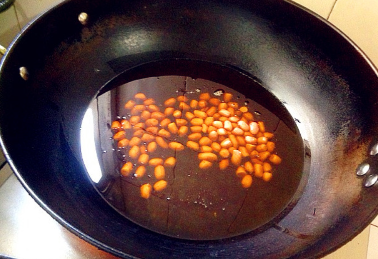 Fry peanuts until 70-80% cooked, then remove from oil.