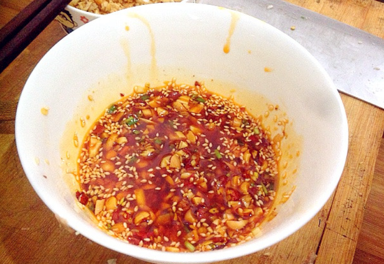 Combine soy sauce, sesame oil, garlic, ginger, green onions, peanuts with chili oil. Adjust salt to taste.