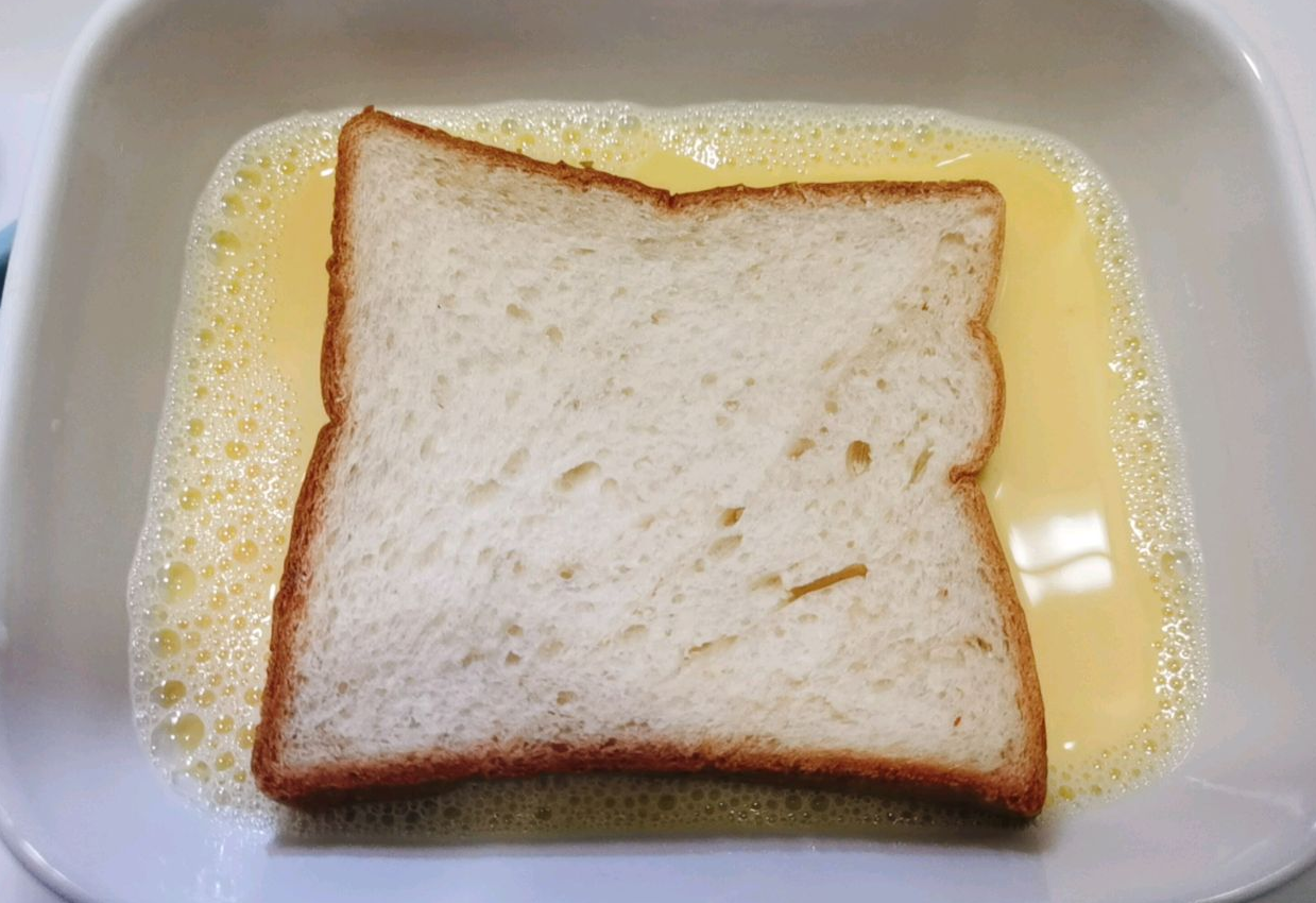 Soak white bread slices in egg-milk mixture for 2-3 minutes to absorb flavor.