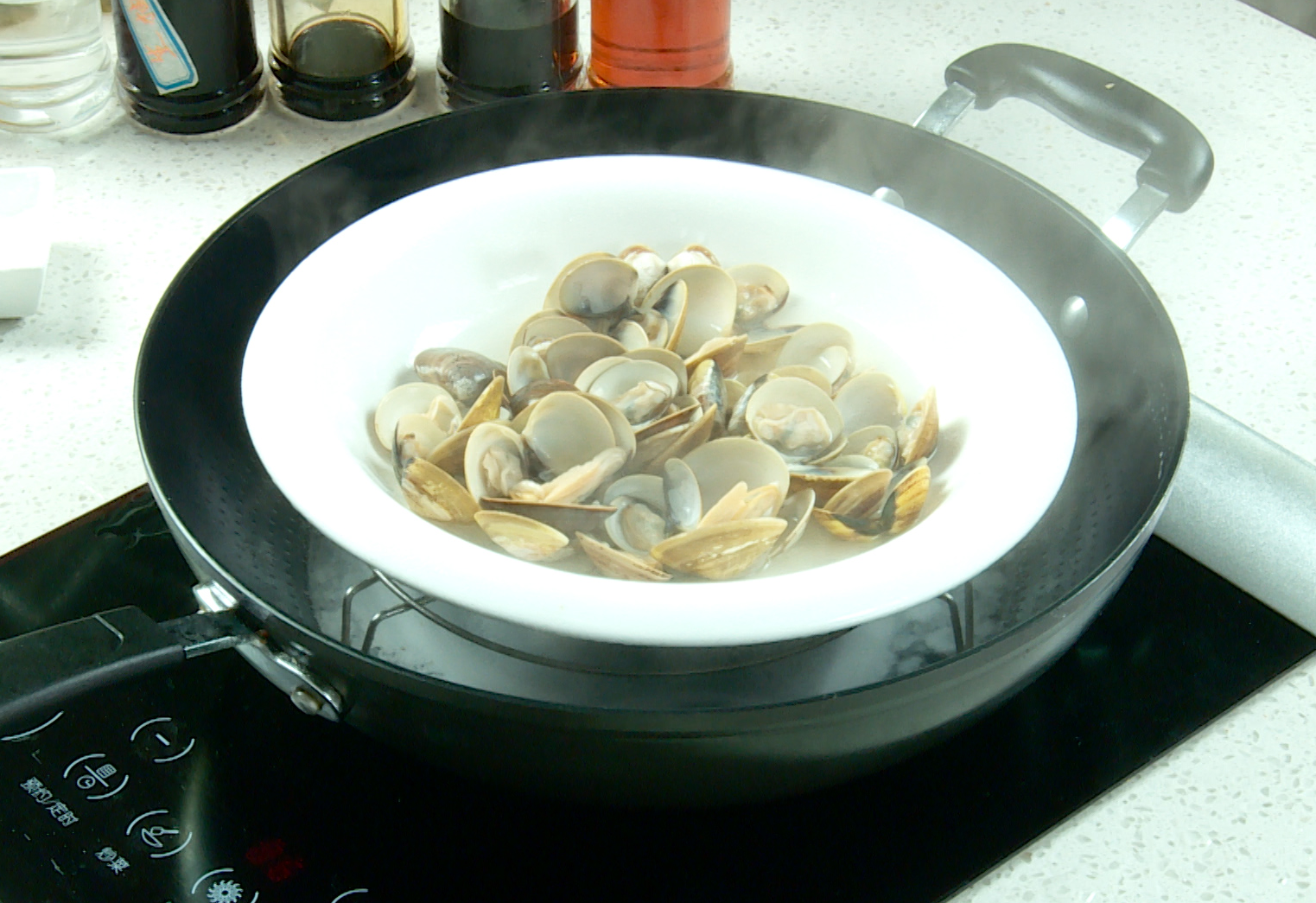 Steam clams in a pot with water and a steaming rack; strain and reserve clam juice.