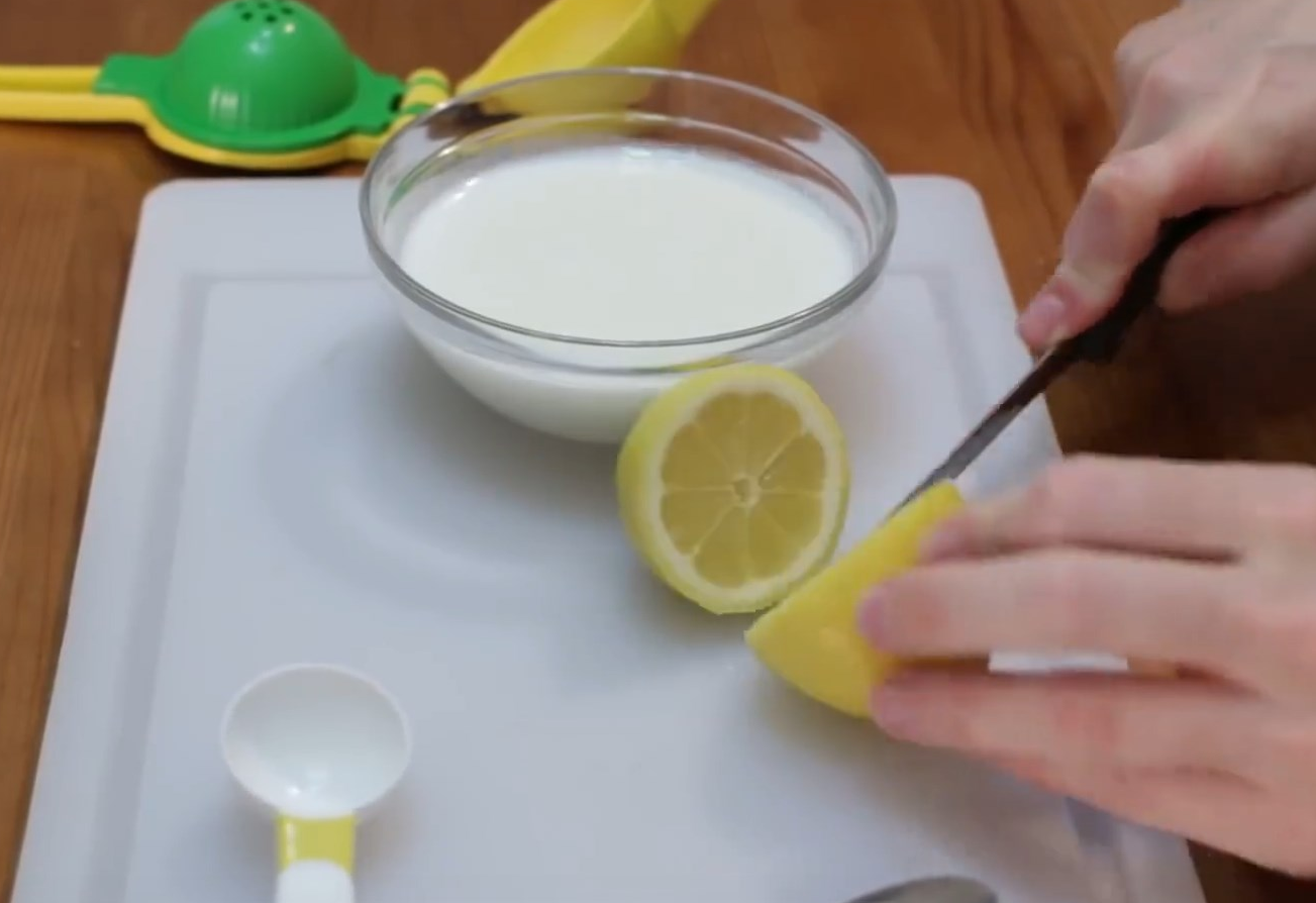 Instruction to wash and cut a lemon in half.