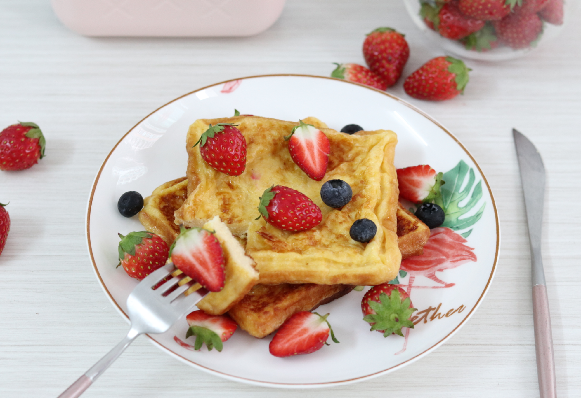 Make golden brown toast and garnish with strawberries; Add blueberries for extra flavor.