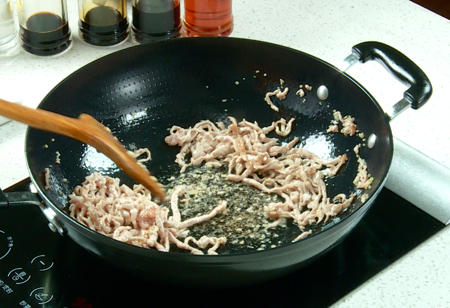 Stir-fry beef with ginger in a hot wok until cooked.