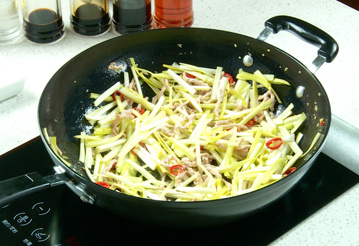 Add vegetables: stir-fry chili pepper and yellow chives until tender.