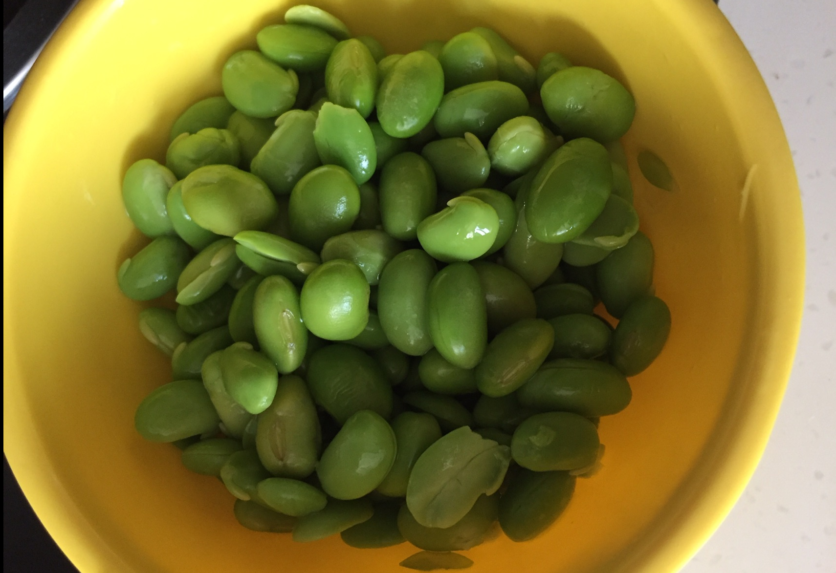 Peel outer skin from edamame and save.