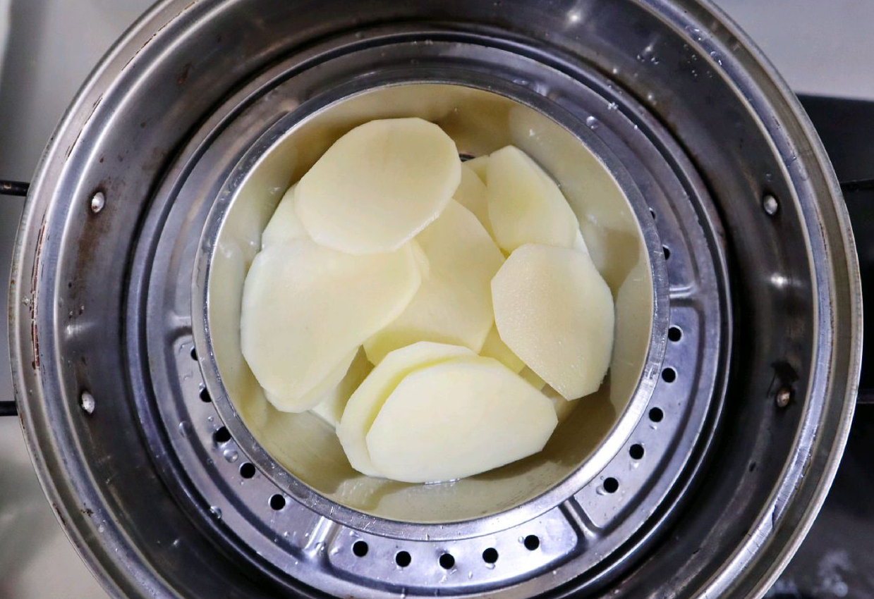 Steam sliced potatoes for 15-20 minutes until tender.