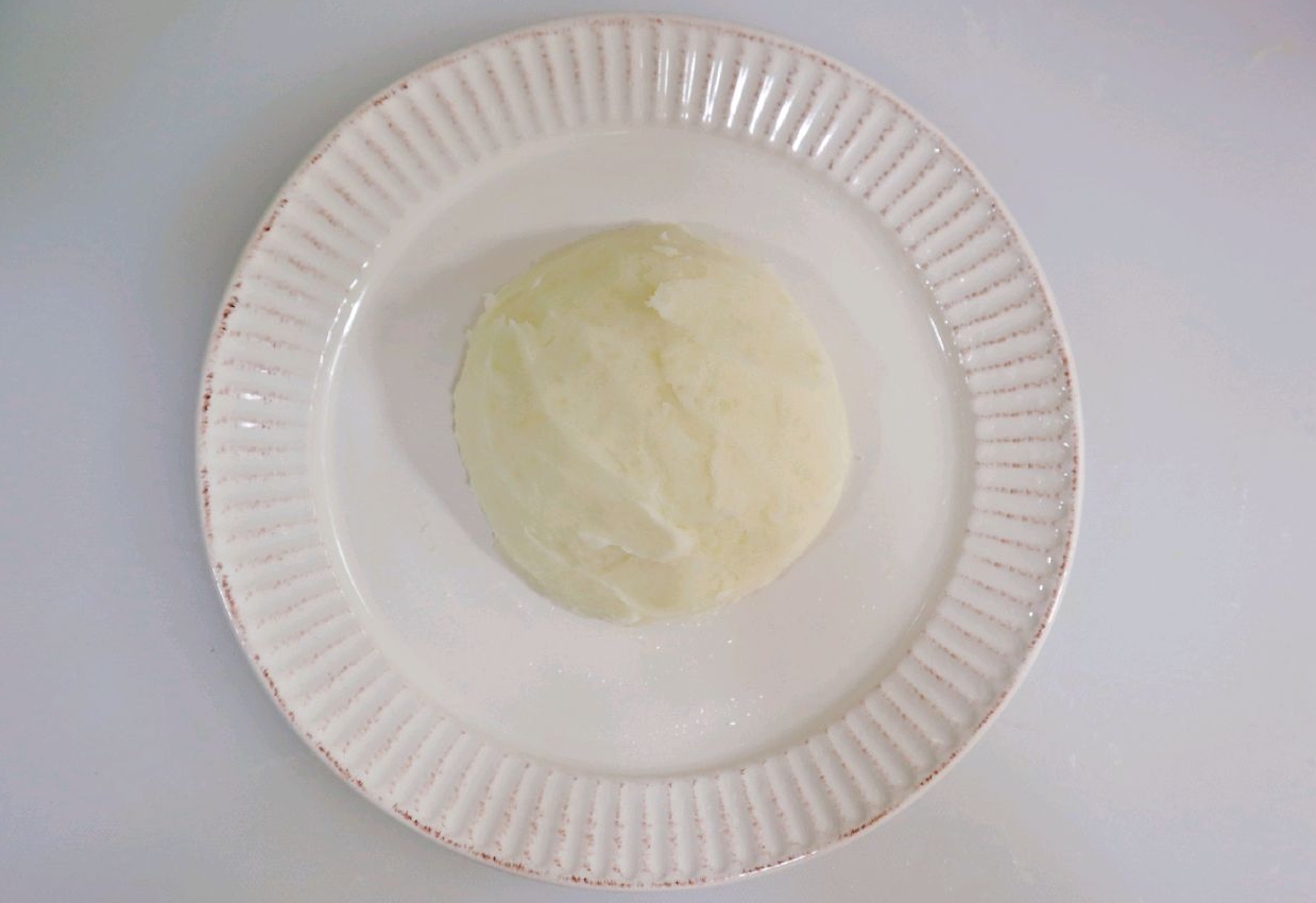 Mashed potatoes transferred to plate and set aside without plastic wrap.