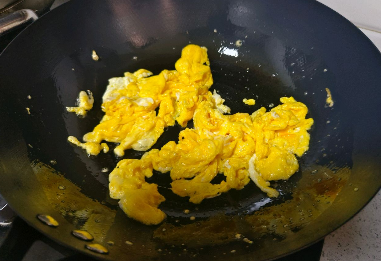 Cook eggs to 80% doneness, then remove from pan.