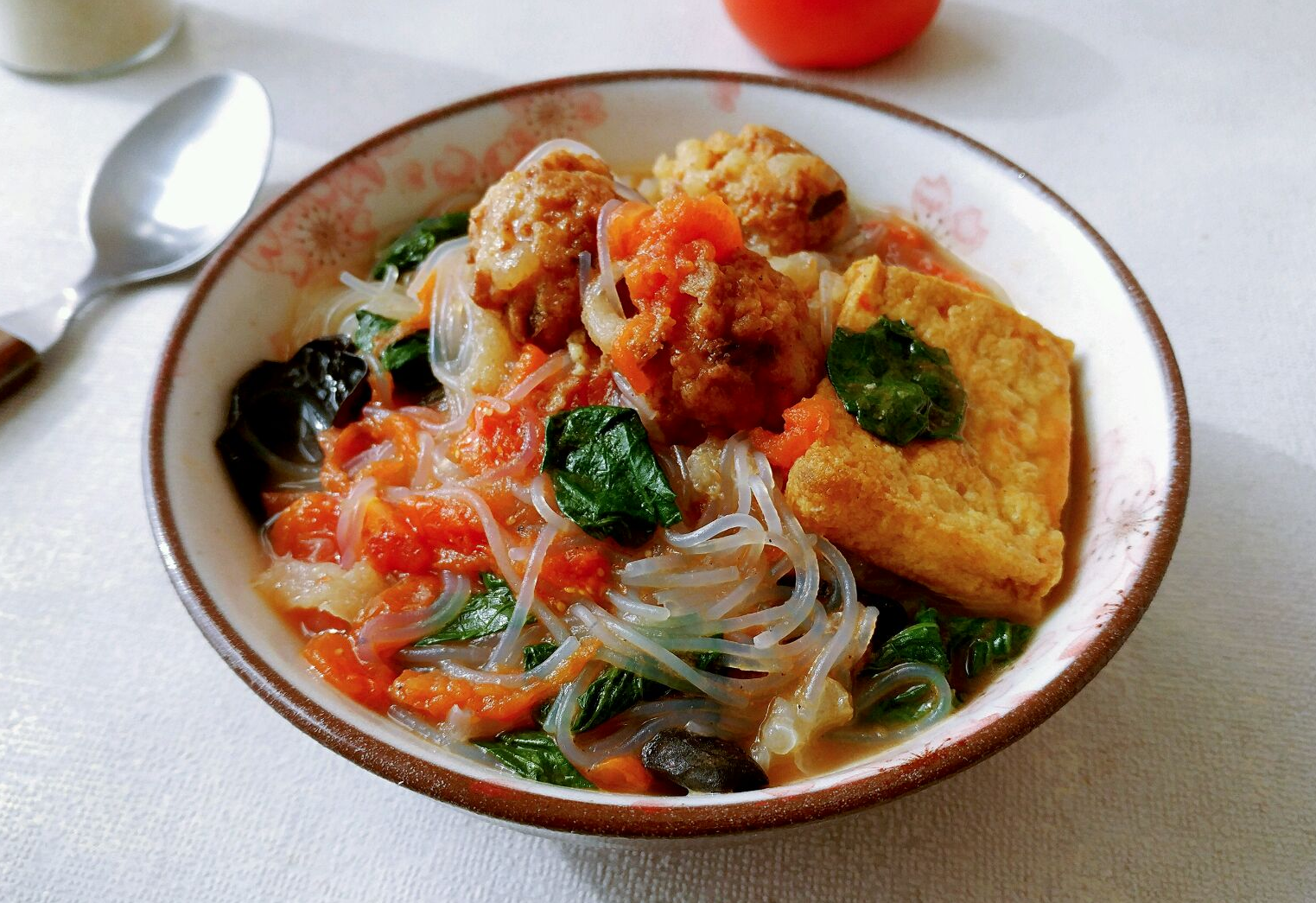 Serve glass noodle soup by transferring noodles and soup to a bowl.