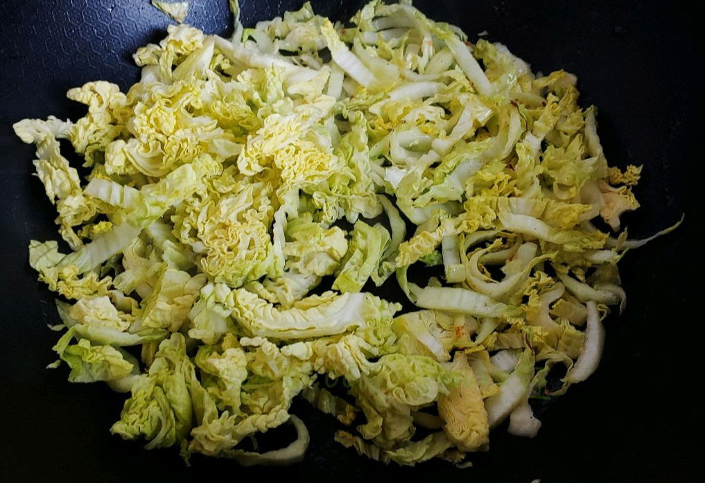 Stir-fry briefly, then add yellow bok choy leaves.