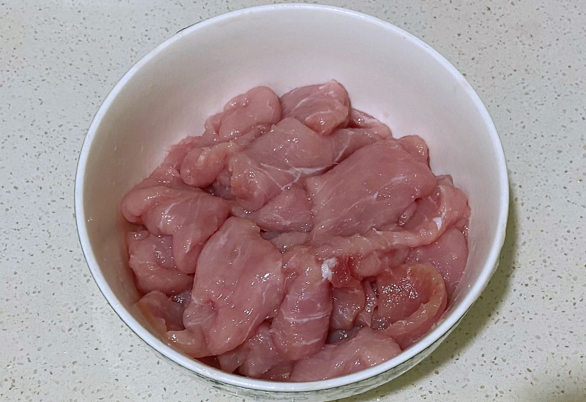 Soak pork tenderloin in water, season with salt for glossy appearance in Guo Bao Rou dish.