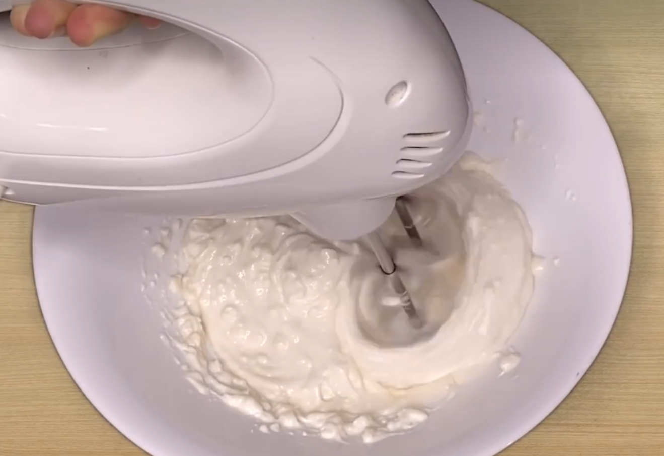 Whip cream with a mixer continuously.