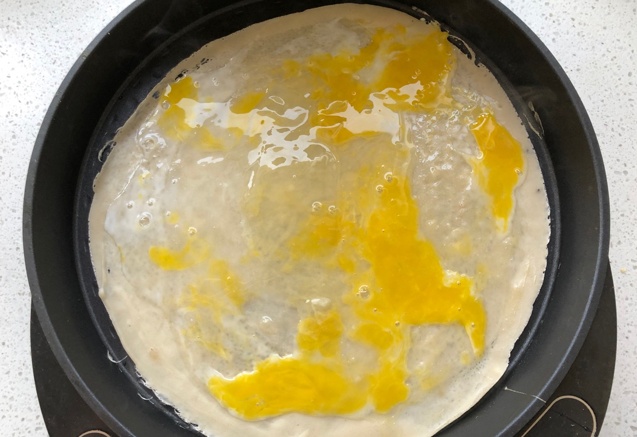 Instructions: Crack an egg onto set batter and scramble.