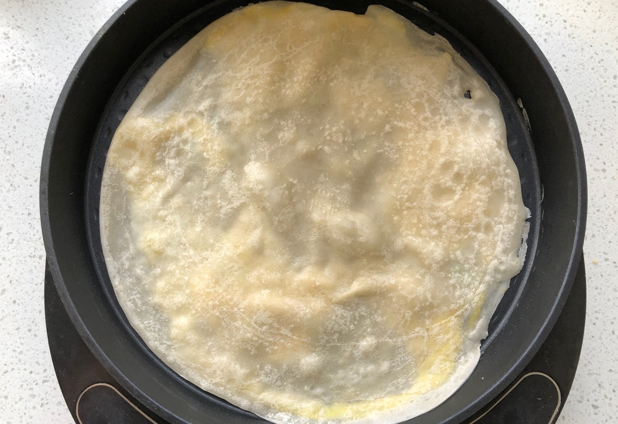 Flip pancake after egg is set.